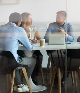 People talking in a glass office room